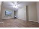 Bonus room showcasing a ceiling fan, light-colored walls and wood flooring at 5347 Harbury Cv, Suwanee, GA 30024