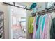 Walk in closet features clothing racks and shelves for ample storage at 5347 Harbury Cv, Suwanee, GA 30024