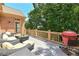 Relaxing deck featuring outdoor seating and a red grill, ideal for summer cookouts at 5347 Harbury Cv, Suwanee, GA 30024