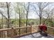 Expansive outdoor deck area with a scenic view and a barbecue grill at 5347 Harbury Cv, Suwanee, GA 30024