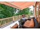 Cozy outdoor deck area with wicker furniture and a grill, set amongst a lush, green backdrop at 5347 Harbury Cv, Suwanee, GA 30024