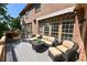 Spacious deck with wicker furniture, barbecue, and retractable awning, perfect for outdoor entertaining at 5347 Harbury Cv, Suwanee, GA 30024