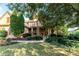 Beautiful two-story brick home with manicured lawn and mature trees providing shade at 5347 Harbury Cv, Suwanee, GA 30024