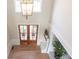 Welcoming two-story foyer with double doors, chandelier, hardwood floors, and staircase at 5347 Harbury Cv, Suwanee, GA 30024