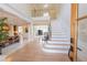 Bright foyer with a staircase, wood floors, and views of the dining and living spaces at 5347 Harbury Cv, Suwanee, GA 30024