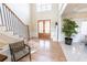 Bright and airy foyer features a staircase, wood floors, and a double-door entry at 5347 Harbury Cv, Suwanee, GA 30024