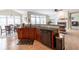 Kitchen with granite countertops, island, wood cabinets, stainless steel appliances and dining area at 5347 Harbury Cv, Suwanee, GA 30024