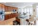 Kitchen with granite countertops, wooden cabinets, island and stainless steel appliances at 5347 Harbury Cv, Suwanee, GA 30024