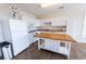 Bright kitchen features white cabinets, wood floors, stainless steel appliances, and a kitchen island at 5347 Harbury Cv, Suwanee, GA 30024