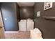 Laundry room with a full-size washer and dryer, grey walls and neutral-colored flooring at 5347 Harbury Cv, Suwanee, GA 30024