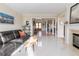 Bright, open living room featuring a fireplace, modern furnishings and pristine marble floors at 5347 Harbury Cv, Suwanee, GA 30024