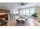Open concept featuring living room, kitchen and dining with hardwood floors and natural light at 5347 Harbury Cv, Suwanee, GA 30024