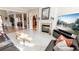 Spacious living room features a fireplace, a large screen television and marble floors at 5347 Harbury Cv, Suwanee, GA 30024