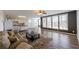 Open concept living area with hardwood floors, large windows, and modern furnishings at 5347 Harbury Cv, Suwanee, GA 30024