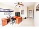 Inviting office space featuring a large wooden desk, comfortable chair, and ample natural light at 5347 Harbury Cv, Suwanee, GA 30024