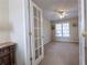 Office features a window with blinds, neutral walls, carpeted floor and a glass paneled french door at 5347 Harbury Cv, Suwanee, GA 30024