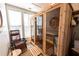 Relaxing sauna with seating and natural light with wood walls and glass door at 5347 Harbury Cv, Suwanee, GA 30024