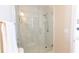 Modern bathroom shower featuring marble-style tiling, glass enclosure, and sleek fixtures at 5347 Harbury Cv, Suwanee, GA 30024