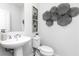 Elegant half bathroom with a modern sink, decorative art, and a sleek toilet at 335 Skylar Se Way, Atlanta, GA 30315