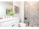 Bright bathroom featuring a marble-tiled shower, white vanity with elegant fixtures, and decorative accents at 335 Skylar Se Way, Atlanta, GA 30315