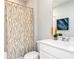 Bathroom showcasing a bathtub with a shower curtain, vanity, and decor at 335 Skylar Se Way, Atlanta, GA 30315