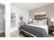 Bedroom with a neutral palette featuring a bed, nightstand and connecting hallway and bath at 335 Skylar Se Way, Atlanta, GA 30315