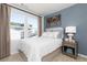 Cozy bedroom with a comfortable bed, side table, stylish wall decor, and a bright window at 335 Skylar Se Way, Atlanta, GA 30315