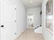 Hallway with carpeted floor, white door, and view into a naturally lit bedroom at 335 Skylar Se Way, Atlanta, GA 30315