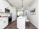 Modern white kitchen with stainless steel appliances, island, and open layout at 335 Skylar Se Way, Atlanta, GA 30315