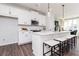 Modern kitchen featuring white cabinets, stainless steel appliances, and a spacious island with seating at 335 Skylar Se Way, Atlanta, GA 30315