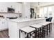 Stylish kitchen with white cabinets, a center island with bar stools, and a sleek microwave at 335 Skylar Se Way, Atlanta, GA 30315