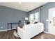 Cozy living room with a plush white sofa, dark wood floors, and natural light from the windows at 335 Skylar Se Way, Atlanta, GA 30315