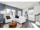 Bright living room with stylish decor, hardwood floors, and comfortable seating arrangements near stairwell at 335 Skylar Se Way, Atlanta, GA 30315
