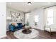 Stylish living room featuring a blue sofa, modern art, and outdoor access at 335 Skylar Se Way, Atlanta, GA 30315