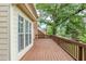 A large wooden deck provides ample space for outdoor enjoyment and overlooks the green backyard at 5611 Manassas Run, Stone Mountain, GA 30087