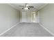 This carpeted bedroom features a ceiling fan and two doorways at 5611 Manassas Run, Stone Mountain, GA 30087