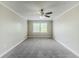 The gray bedroom is brightly lit by natural light from the window and a ceiling fan at 5611 Manassas Run, Stone Mountain, GA 30087