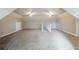 Large bonus room with two ceiling fans and staircase at 5611 Manassas Run, Stone Mountain, GA 30087