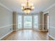 Formal dining room with large bay windows that provide abundant natural light and hardwood floors at 5611 Manassas Run, Stone Mountain, GA 30087