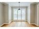 Charming dining room with hardwood floors, pendant lighting, and ample natural light at 5611 Manassas Run, Stone Mountain, GA 30087