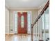 Inviting foyer featuring hardwood floors, and staircase with natural wood banister at 5611 Manassas Run, Stone Mountain, GA 30087