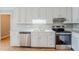 Bright kitchen with white cabinetry, stainless steel appliances, and a stainless steel sink at 5611 Manassas Run, Stone Mountain, GA 30087