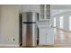 Spacious kitchen featuring stainless steel refrigerator and white cabinets with light countertops at 5611 Manassas Run, Stone Mountain, GA 30087