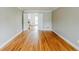 Spacious room featuring hardwood floors and an adjacent room, offering versatility at 5611 Manassas Run, Stone Mountain, GA 30087