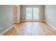 Bright living room with hardwood flooring, neutral walls, and abundant natural light at 5611 Manassas Run, Stone Mountain, GA 30087