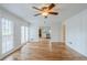 Bright room with hardwood flooring, white wainscoting, and access to the kitchen and patio at 5611 Manassas Run, Stone Mountain, GA 30087