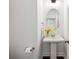 Charming powder room with pedestal sink, oval mirror, and decorative accents at 1977 Boyd Trace Nw Ln, Atlanta, GA 30318