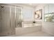 Bright bathroom featuring a soaking tub and glass enclosed shower at 1977 Boyd Trace Nw Ln, Atlanta, GA 30318