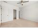 Carpeted bedroom with ceiling fan, white walls, and open closet and doorway at 1977 Boyd Trace Nw Ln, Atlanta, GA 30318
