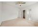 A bright, carpeted bedroom featuring a ceiling fan and multiple doorways at 1977 Boyd Trace Nw Ln, Atlanta, GA 30318
